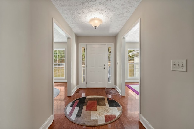 foyer featuring a textured ceiling and hardwood / wood-style flooring