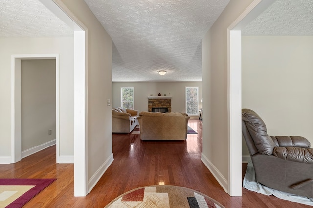 corridor featuring hardwood / wood-style floors and a textured ceiling