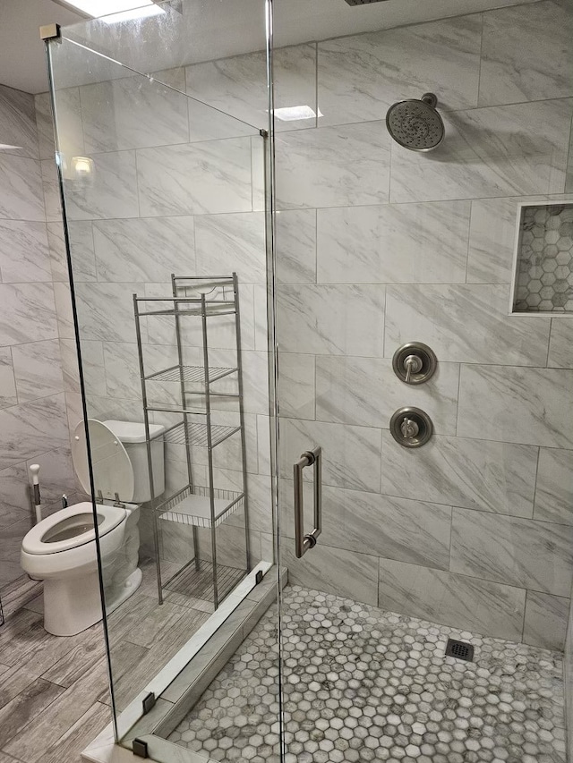 bathroom with toilet and walk in shower