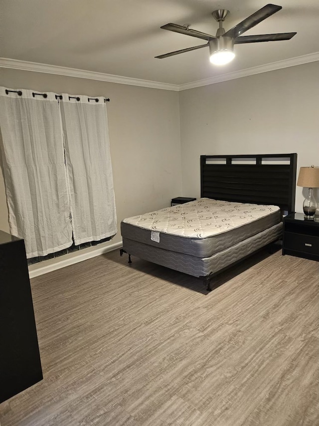 bedroom featuring crown molding, ceiling fan, and hardwood / wood-style flooring