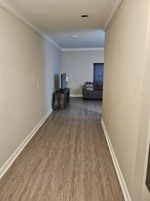 hallway featuring ornamental molding and dark wood-type flooring