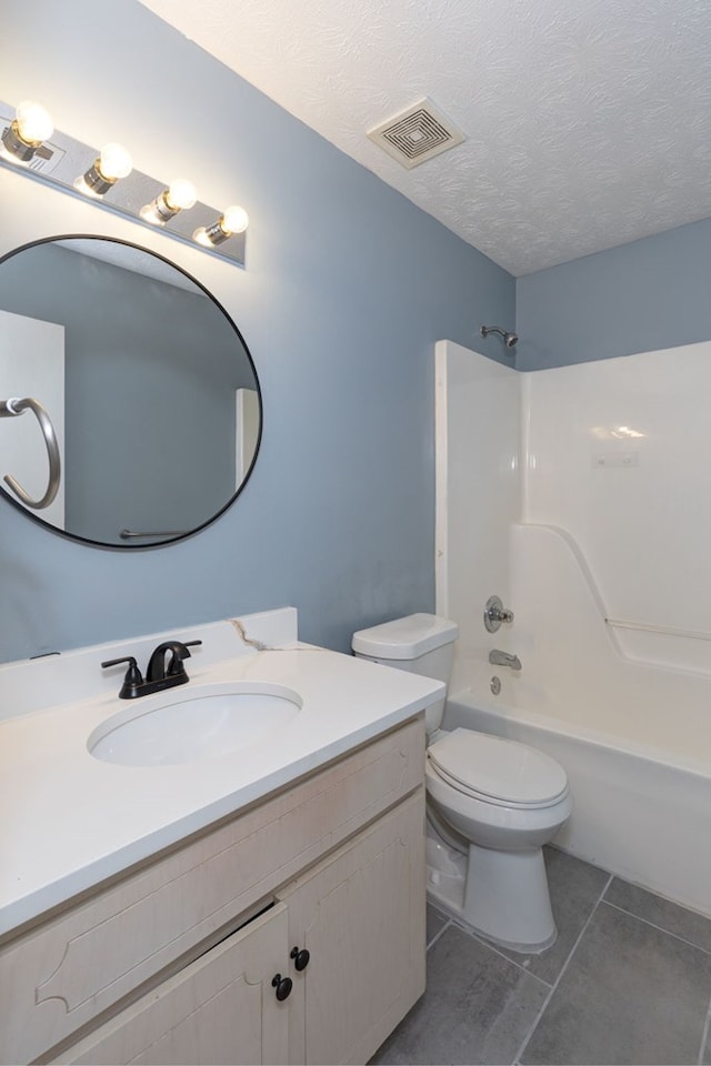 bathroom featuring tile patterned flooring, visible vents, toilet, vanity, and a textured ceiling