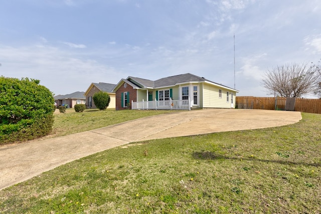 ranch-style house featuring a front yard and fence