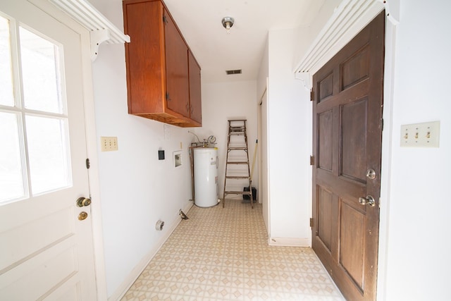 washroom with water heater, washer hookup, and cabinets