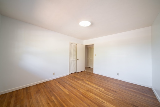 unfurnished room with hardwood / wood-style floors