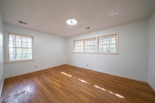 empty room featuring hardwood / wood-style floors and a wealth of natural light