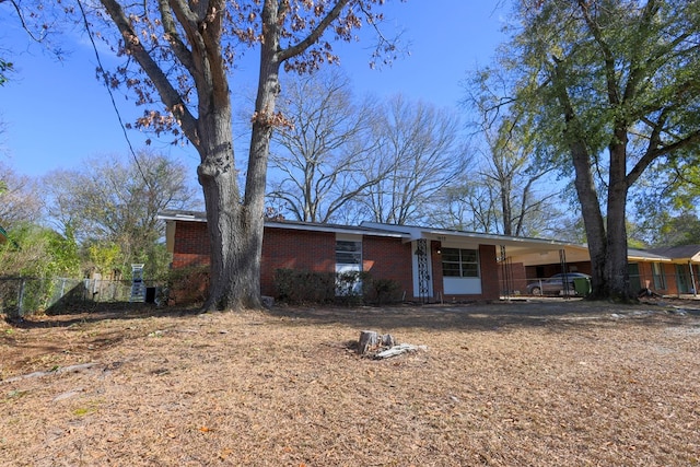 view of front of home with brick siding and fence