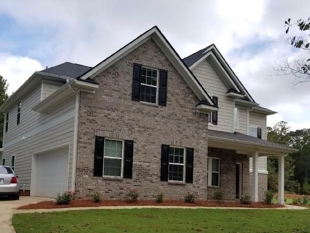 view of front of house featuring an attached garage, concrete driveway, and brick siding