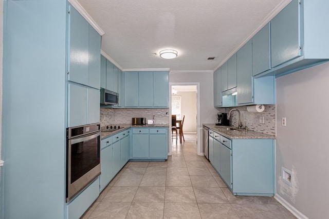 6727 Trapper Way, Midland, GA 31820 - kitchen featuring stainless steel appliances, blue cabinetry, backsplash, crown molding, and light stone counters