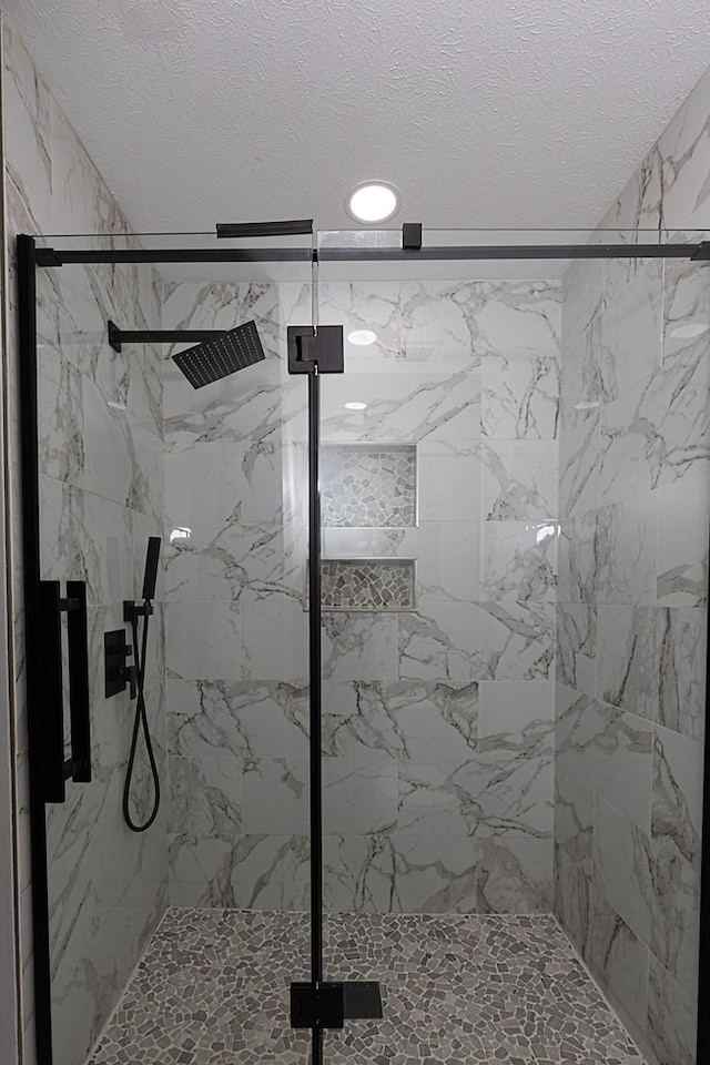 6727 Trapper Way, Midland, GA 31820 - bathroom with a marble finish shower and a textured ceiling