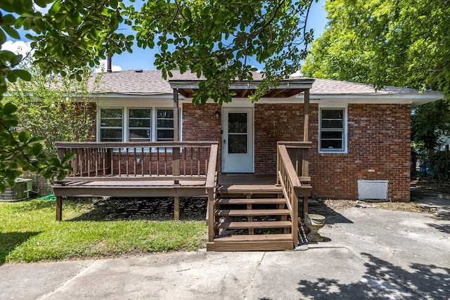3824 Forrest Rd, Columbus, GA 31907 - view of front facade featuring brick siding, a wooden deck, and a shingled roof