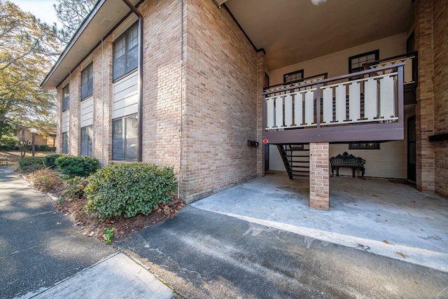 view of side of home featuring a balcony