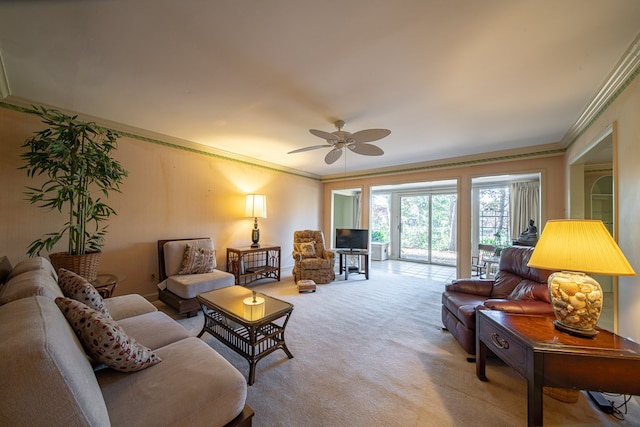 carpeted living room featuring ceiling fan and ornamental molding