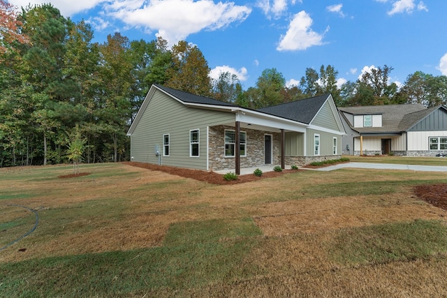 view of side of property with a yard