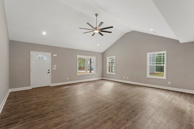 unfurnished living room featuring a wealth of natural light, ceiling fan, dark hardwood / wood-style floors, and high vaulted ceiling