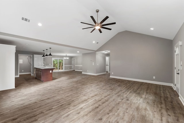 unfurnished living room featuring ceiling fan, sink, high vaulted ceiling, and wood-type flooring