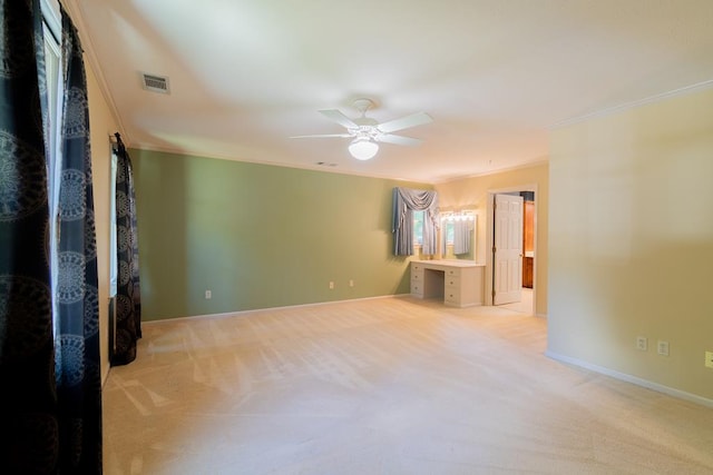 carpeted empty room with ceiling fan and ornamental molding