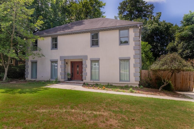 colonial inspired home with a front lawn