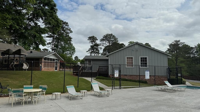 surrounding community with a yard, a patio, and a wooden deck