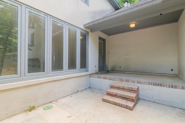 property entrance featuring a patio