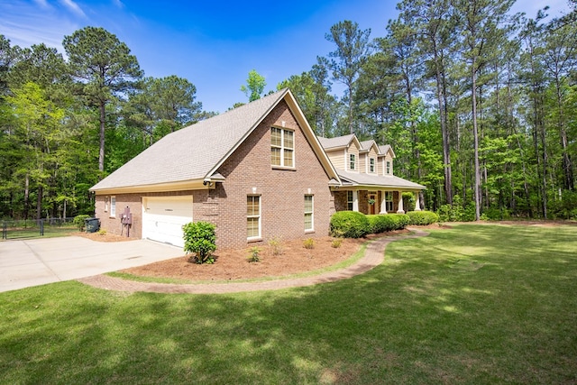 view of home's exterior with driveway, fence, brick siding, a shingled roof, and a yard
