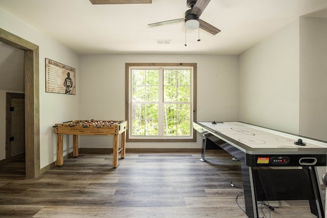 rec room featuring visible vents, baseboards, wood finished floors, and ceiling fan