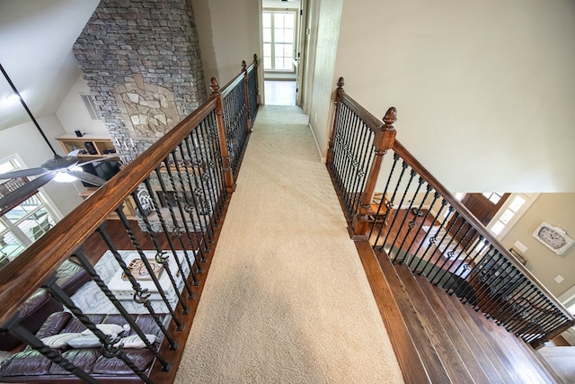 staircase with hardwood / wood-style flooring and high vaulted ceiling