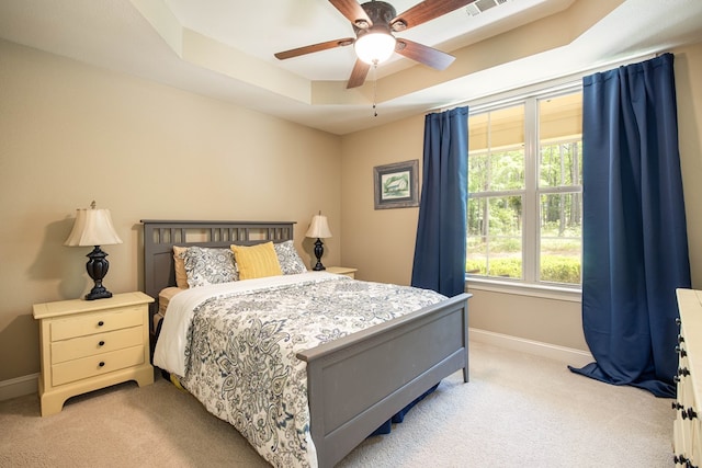 bedroom with visible vents, light carpet, and baseboards