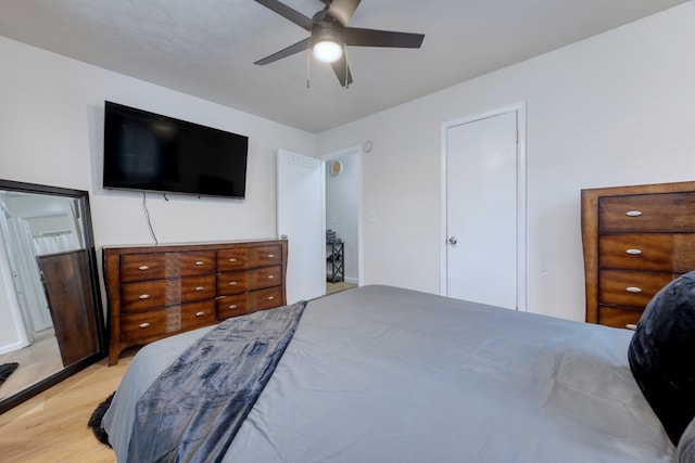 bedroom with ceiling fan and light wood-type flooring