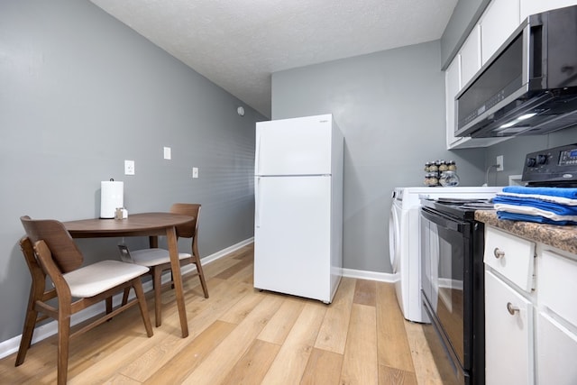 kitchen featuring white cabinets, white fridge, light hardwood / wood-style floors, black electric range, and a textured ceiling