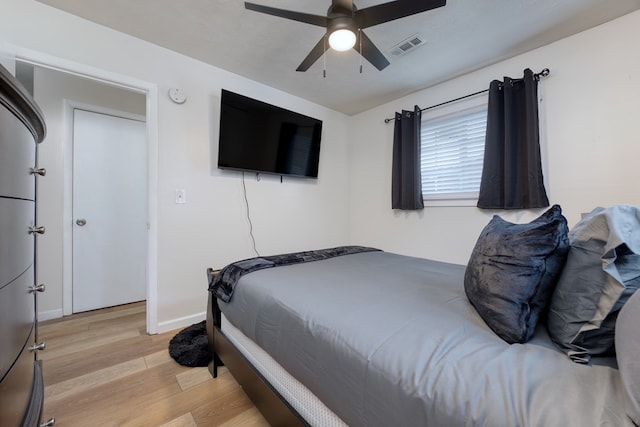 bedroom with ceiling fan and light hardwood / wood-style flooring