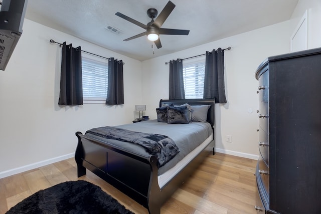 bedroom with ceiling fan and light hardwood / wood-style floors