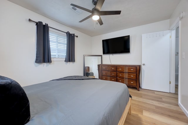 bedroom featuring ceiling fan, a textured ceiling, and light wood-type flooring