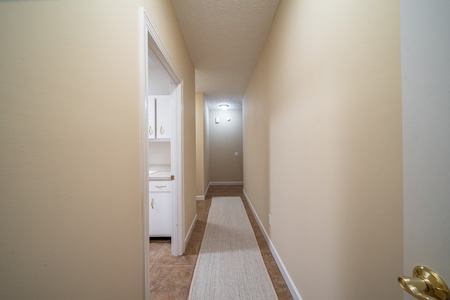 hall with a textured ceiling