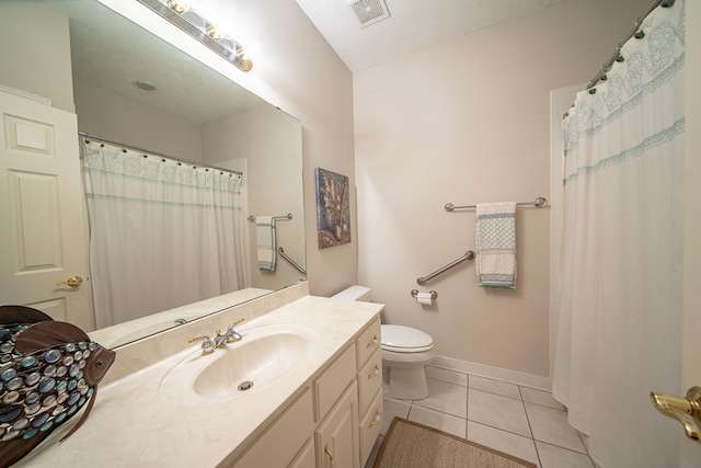 bathroom with toilet, a textured ceiling, vanity, and tile patterned floors