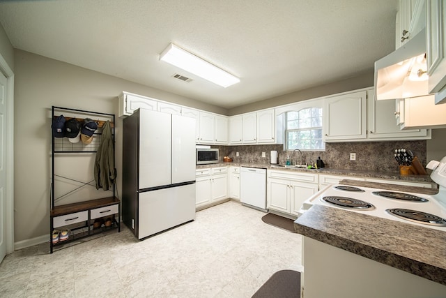 kitchen with white cabinetry, sink, backsplash, a textured ceiling, and white appliances