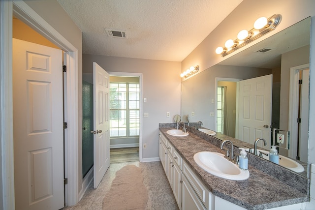 bathroom with vanity and a textured ceiling