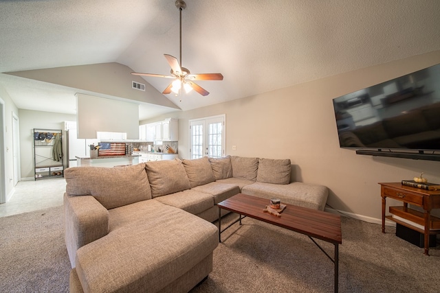 carpeted living room with french doors, ceiling fan, and lofted ceiling