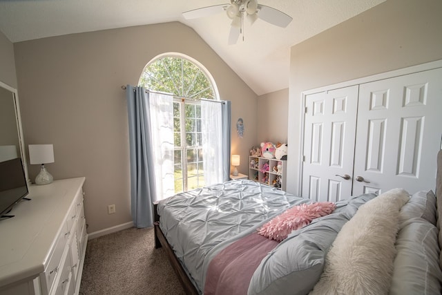 carpeted bedroom featuring ceiling fan, lofted ceiling, and a closet