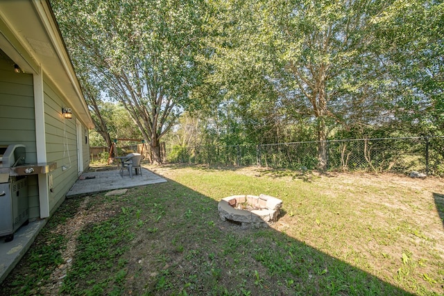 view of yard with a fire pit and a patio