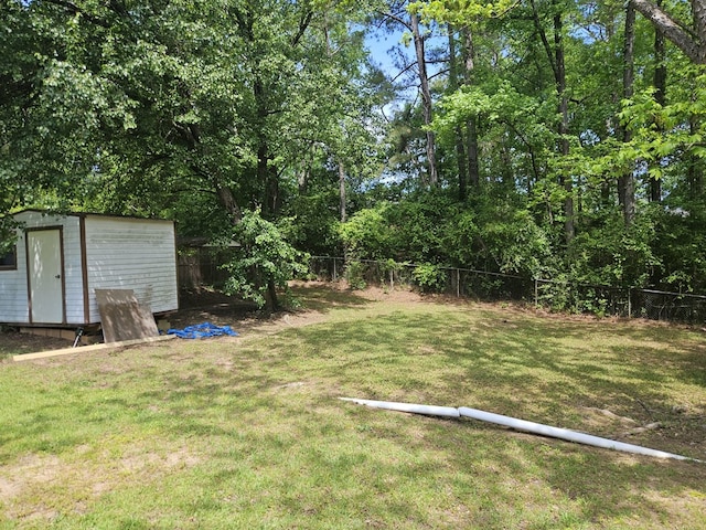 view of yard featuring a fenced backyard, an outbuilding, and a shed