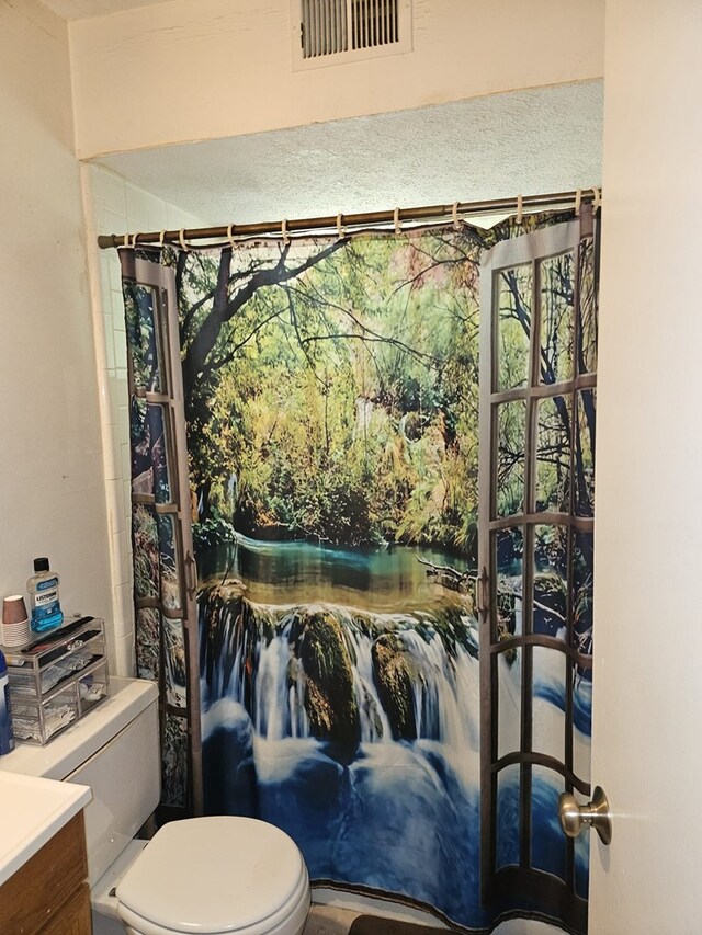 full bathroom featuring visible vents, toilet, and vanity