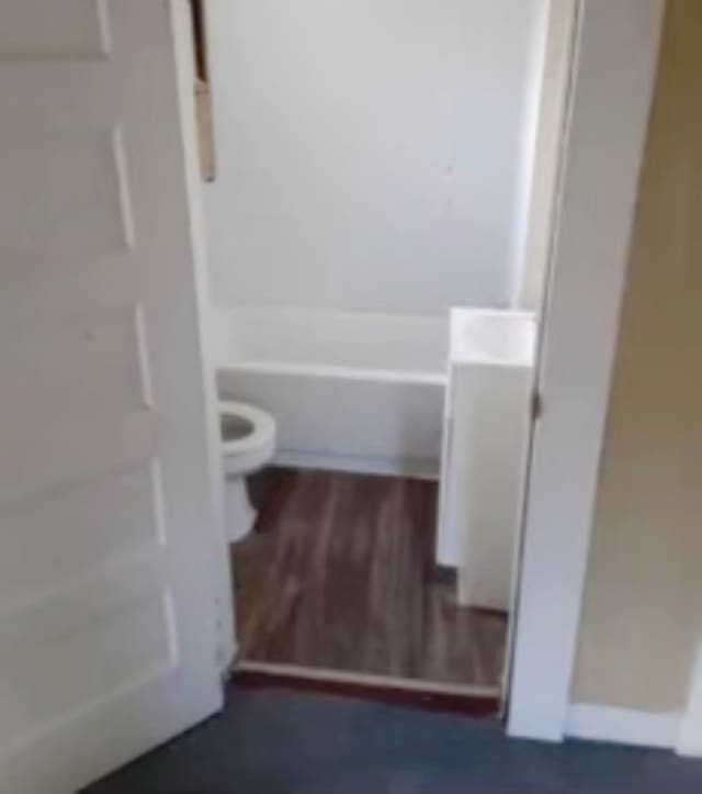 bathroom featuring hardwood / wood-style floors, vanity, and toilet