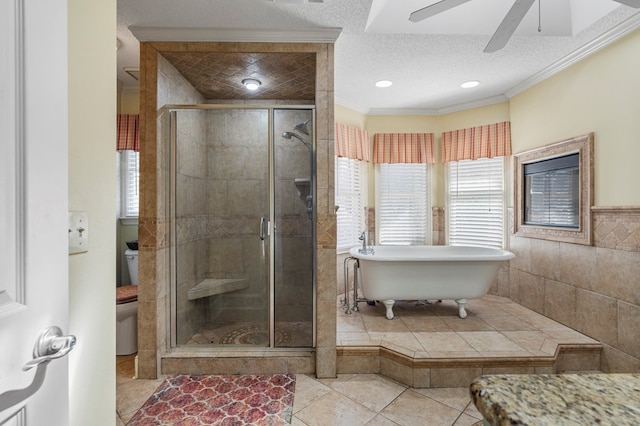 full bath with a shower stall, a textured ceiling, toilet, and ornamental molding