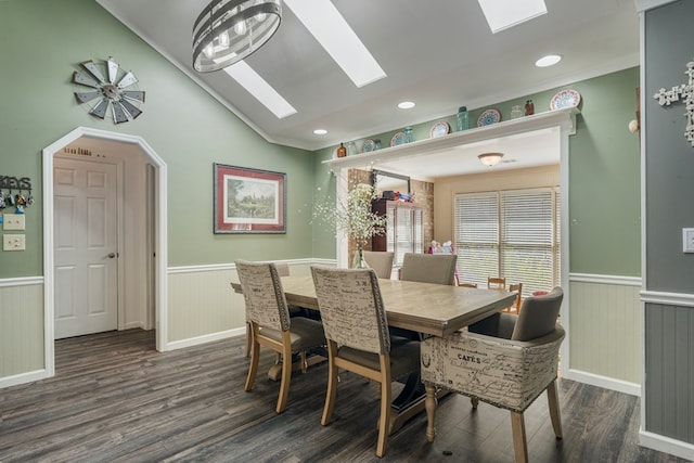 dining room featuring dark wood finished floors, a wainscoted wall, vaulted ceiling with skylight, and recessed lighting