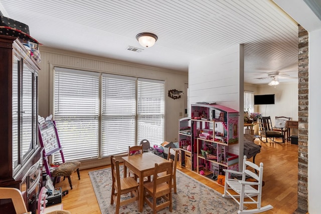 dining area with plenty of natural light, wood finished floors, visible vents, and ceiling fan