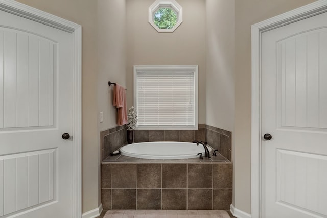 6437 Woodbriar Ln, Midland, GA 31820 - bathroom featuring a garden tub and baseboards
