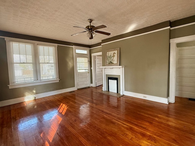 unfurnished living room featuring ceiling fan, wood-type flooring, and a textured ceiling