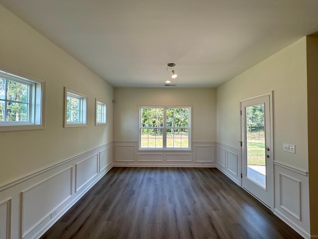 empty room with dark hardwood / wood-style floors