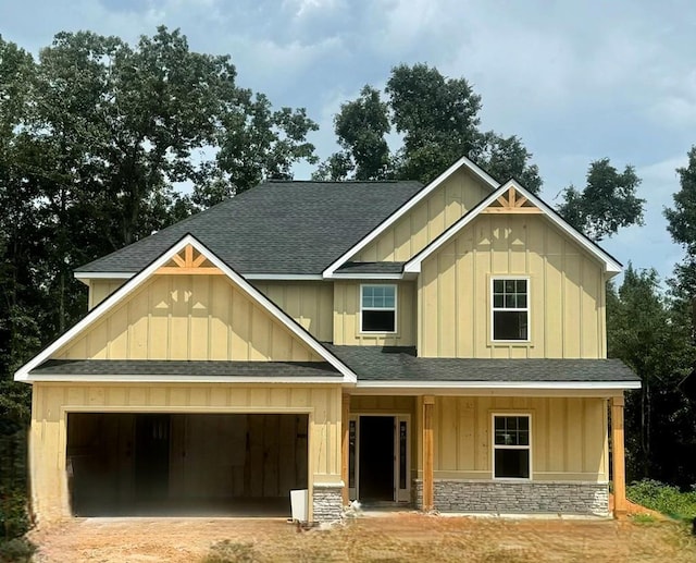 view of front of property featuring a porch and a garage